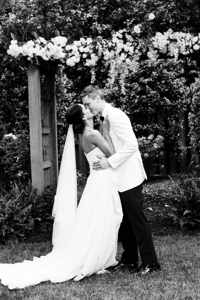 Bride and groom share a wedding kiss at the alter