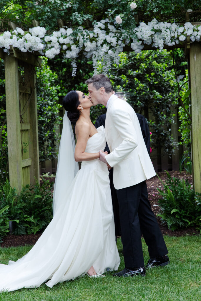 Bride and groom kiss at the alter in a garden in Richmond VA