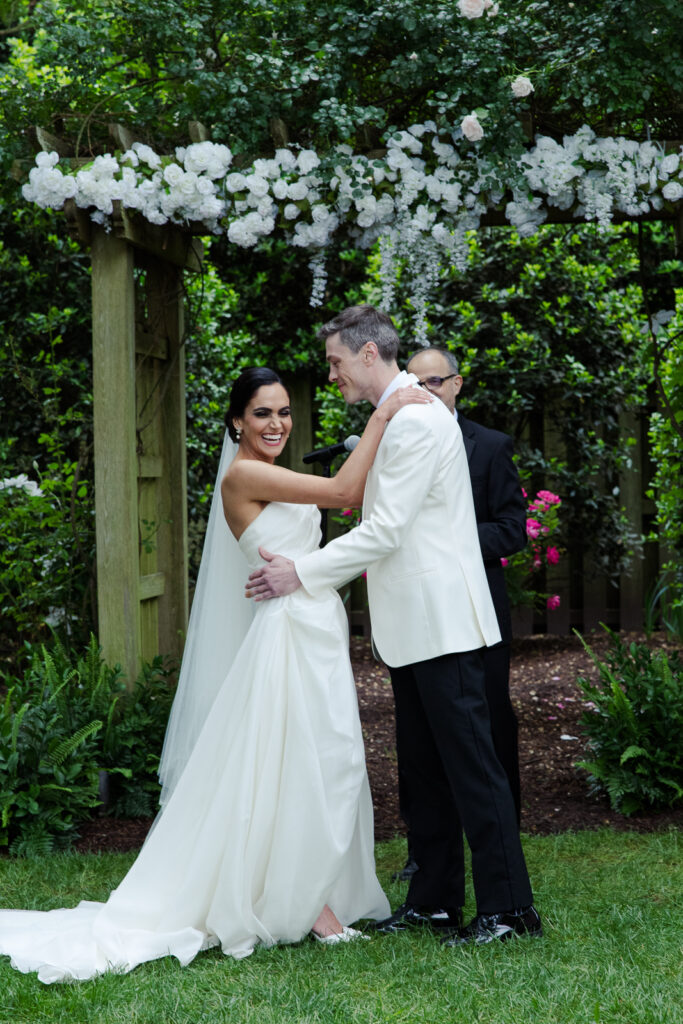 Bride and groom laugh after being pronounced husband and wife at the alter