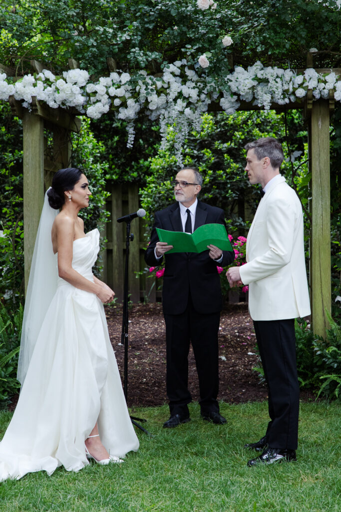 Persian bride and American groom wed under garden archway at Tuckahoe Women's Club in Richmond VA.