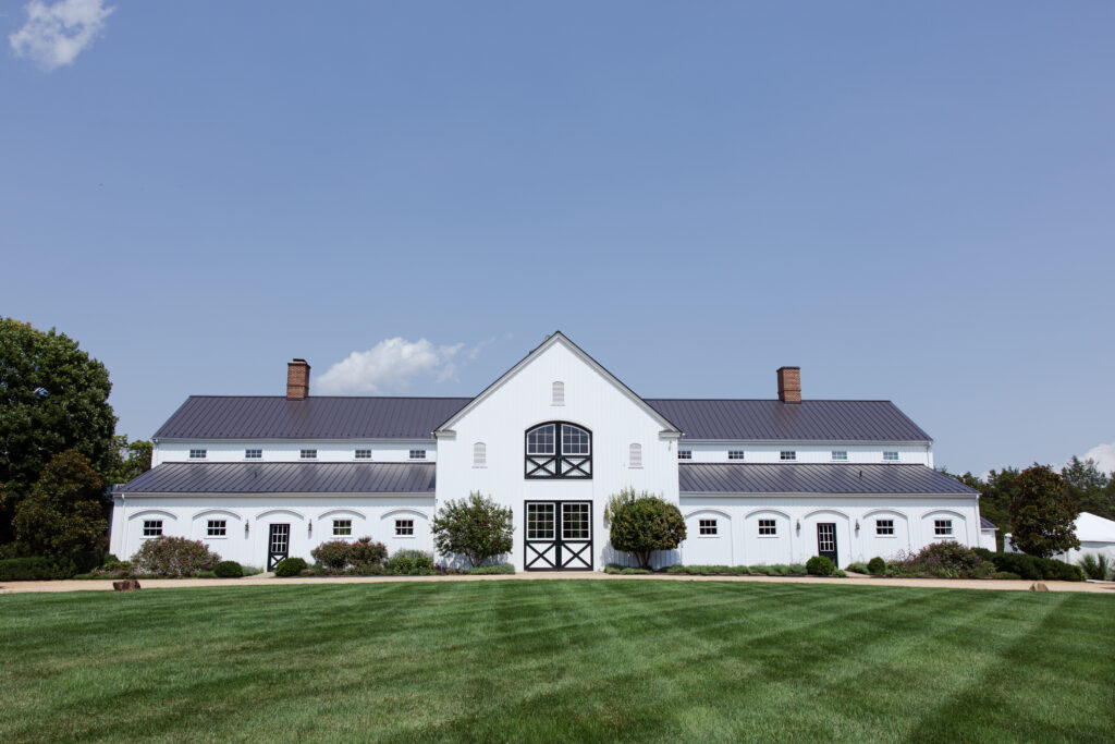 Large white luxurious barn for wedding use.