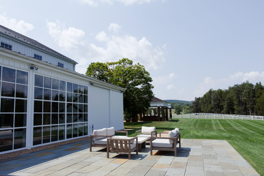 Patio with furniture and beautiful Charlottesville scenery backdrop.